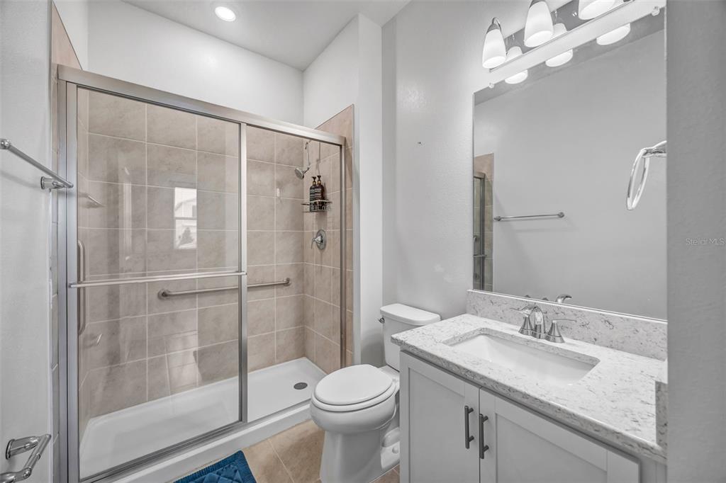 7882 Lennox Loop Wesley Chapel, FL 33544 - Photo 25 of 58 a bathroom with a sink toilet and shower