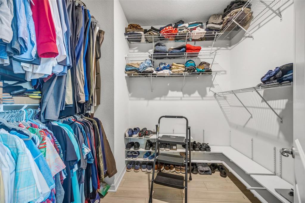 7882 Lennox Loop Wesley Chapel, FL 33544 - Photo 38 of 58 a view of walk in closet with clothes and shoes