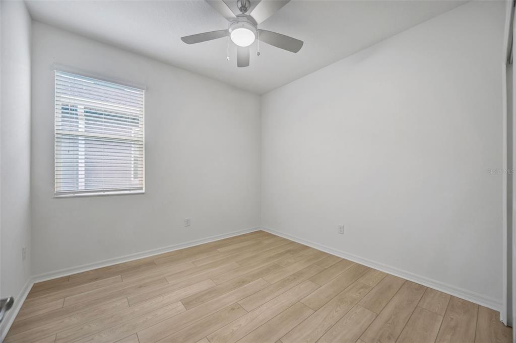 7882 Lennox Loop Wesley Chapel, FL 33544 - Photo 45 of 58 an empty room with a window and a fan