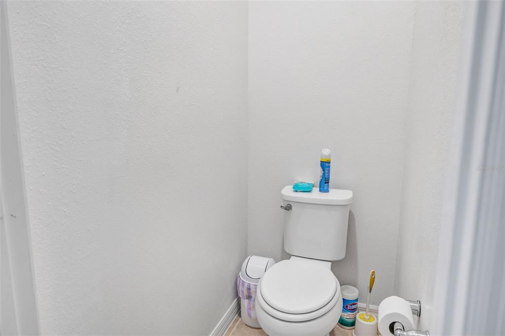 7882 Lennox Loop Wesley Chapel, FL 33544 - Photo 51 of 58 a white toilet sitting next to a white wall