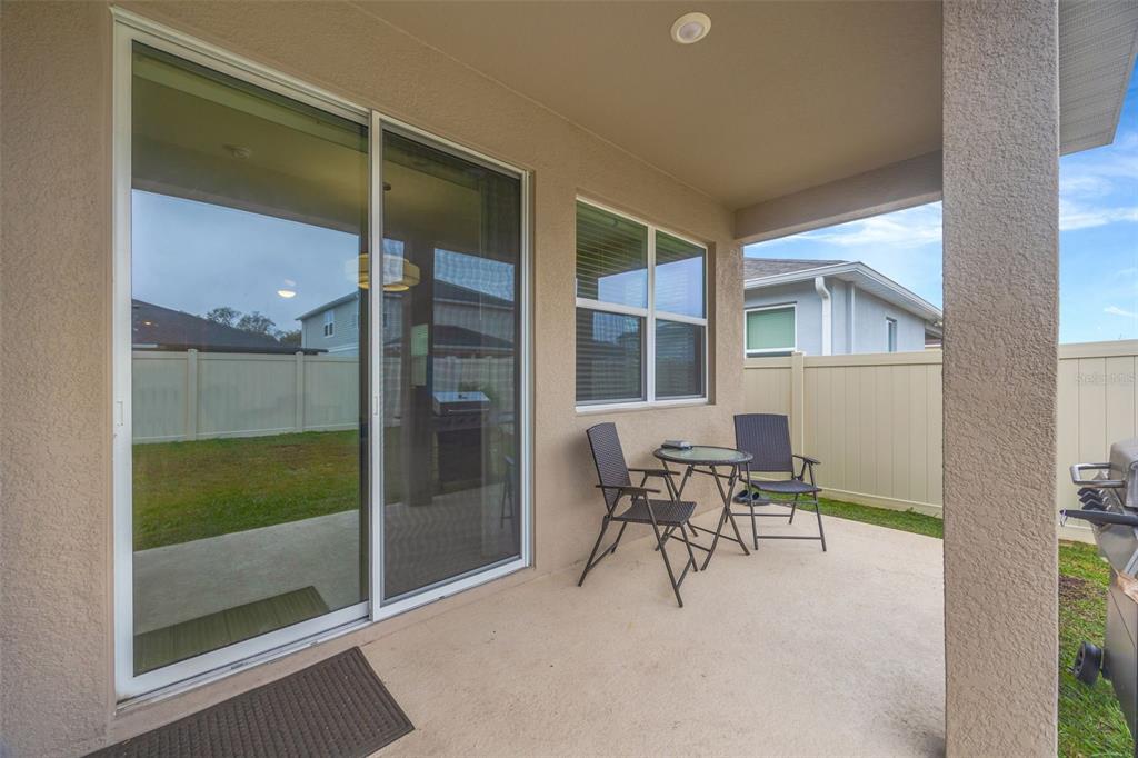 7882 Lennox Loop Wesley Chapel, FL 33544 - Photo 53 of 58 a balcony with table and chairs