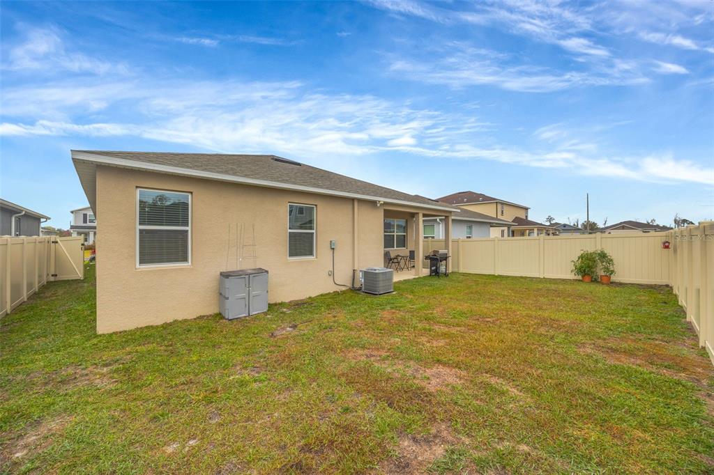 7882 Lennox Loop Wesley Chapel, FL 33544 - Photo 55 of 58 a view of a house with backyard and lake view
