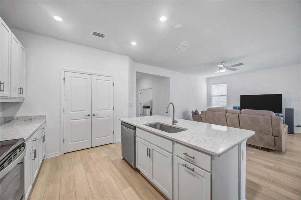 7882 Lennox Loop Wesley Chapel, FL 33544 - Photo 10 of 58 a kitchen that has a sink and a stove in it