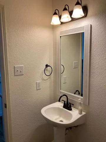 a bathroom with a sink and mirror