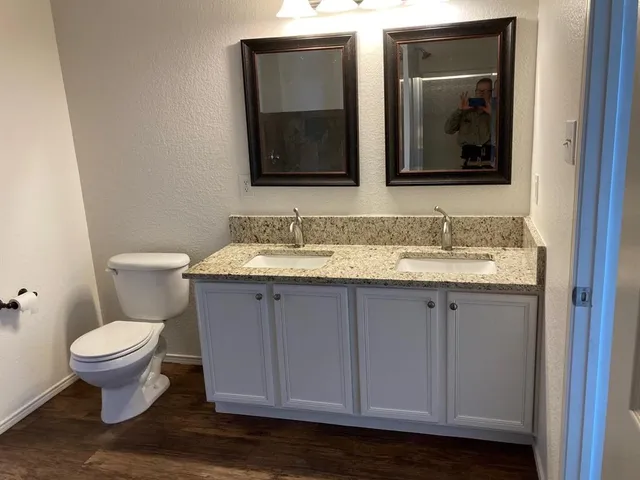 a bathroom with a toilet sink and mirror