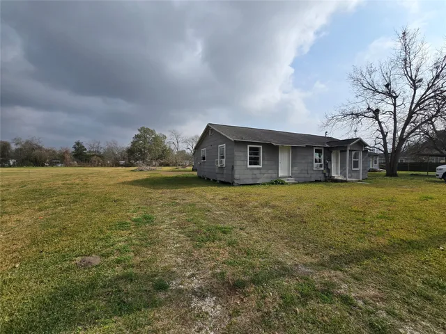 a house view with swimming pool in front of it