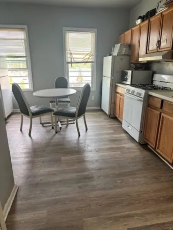 a workspace with furniture hardwood and a window