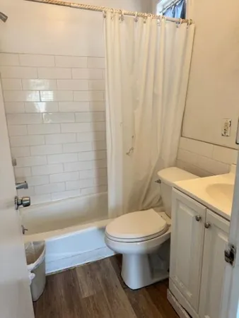 a bathroom with a toilet and a shower