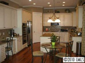 747 Quicksilver Trail Fort Mill, SC 29708 - Photo 4 of 8 a kitchen with stainless steel appliances a dining table chairs and a refrigerator