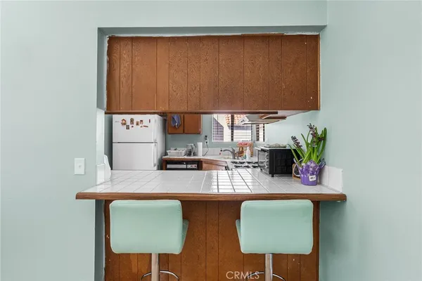 a kitchen with a sink cabinets and a window