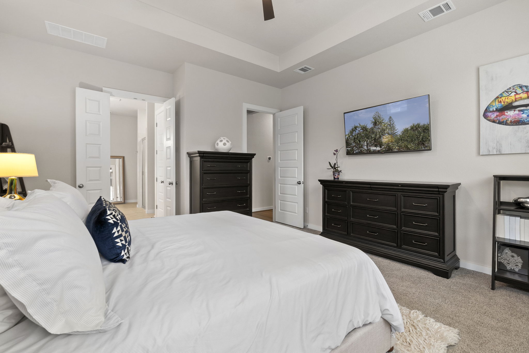 460 Constitution Way Kyle, TX 78640 - Photo 18 of 40 Recessed tray ceiling, light gray wall paint, white trim, five-panel interior doors, and carpet flooring