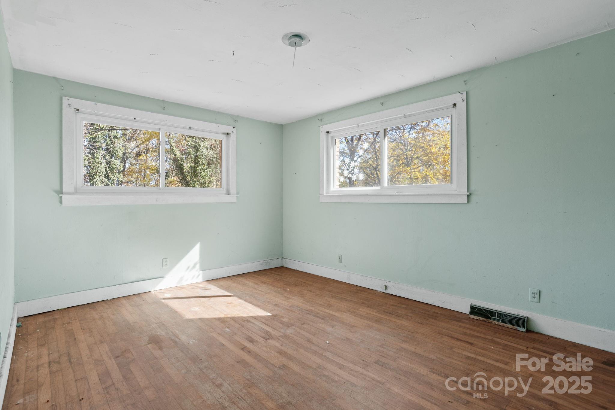 601 East Blue Ridge Road East Flat Rock, NC 28726 - Photo 13 of 48 a view of an empty room with wooden floor and a window