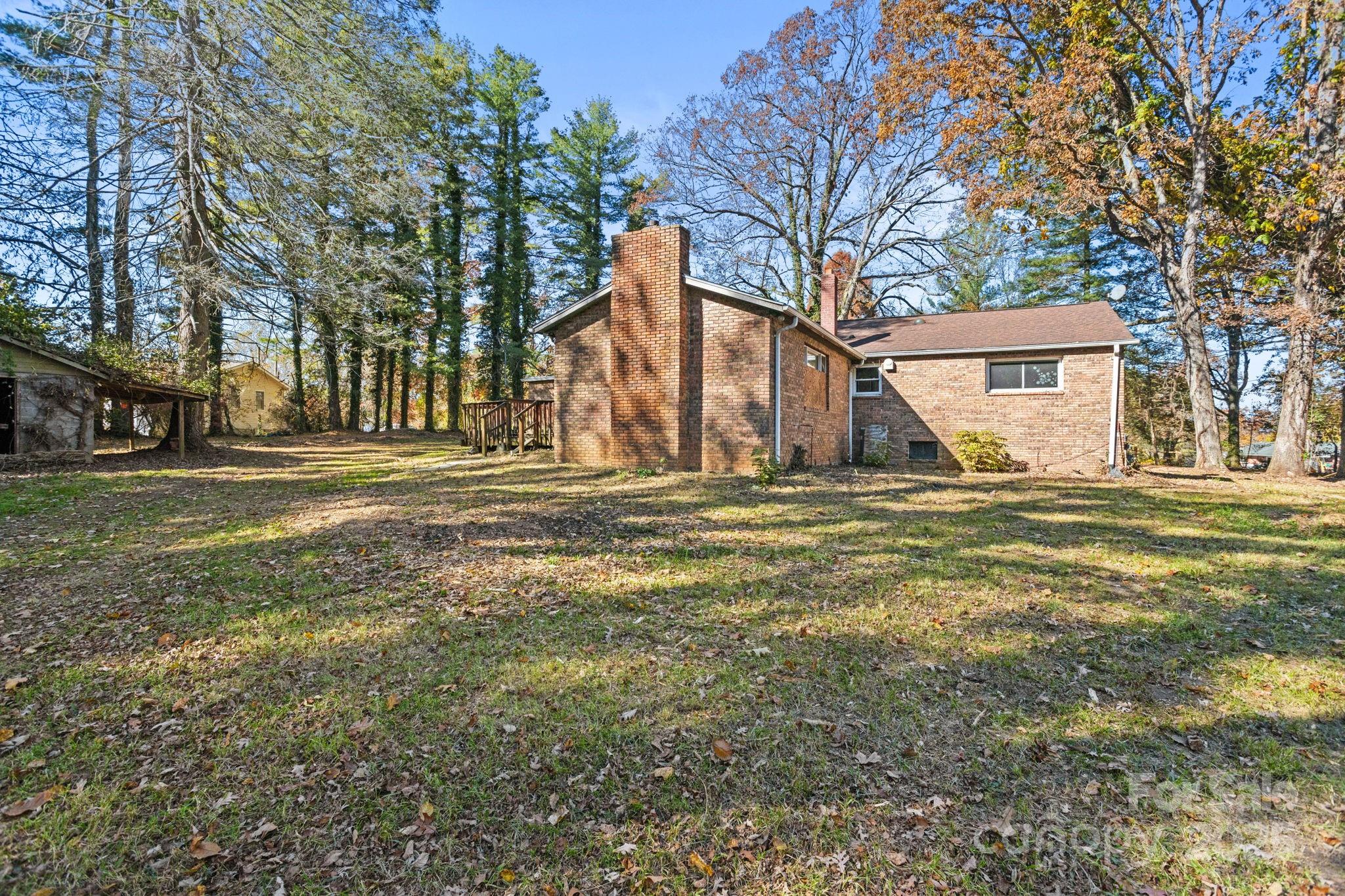 601 East Blue Ridge Road East Flat Rock, NC 28726 - Photo 17 of 48 a view of a house with a yard