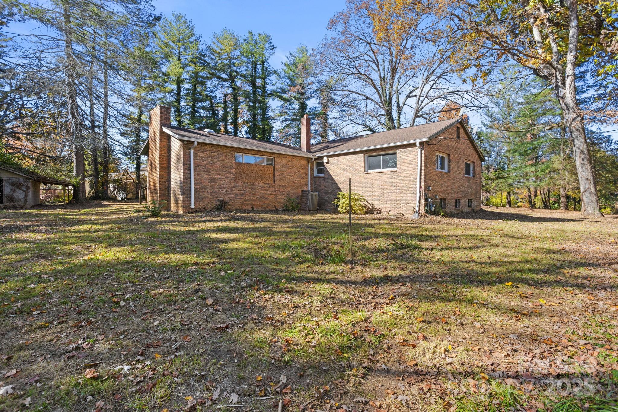 601 East Blue Ridge Road East Flat Rock, NC 28726 - Photo 19 of 48 a view of a house with a yard