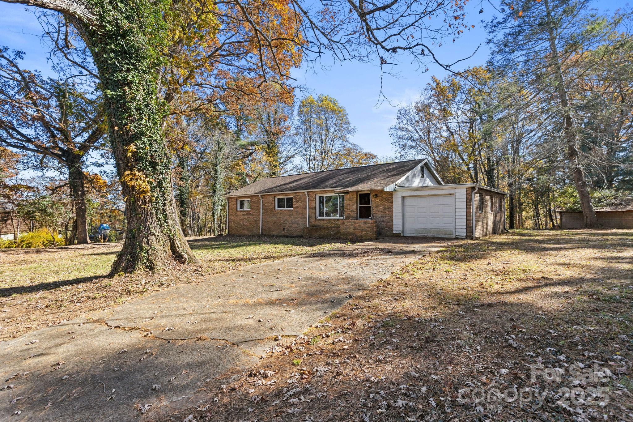 601 East Blue Ridge Road East Flat Rock, NC 28726 - Photo 2 of 48 a view of a house with snow on the road
