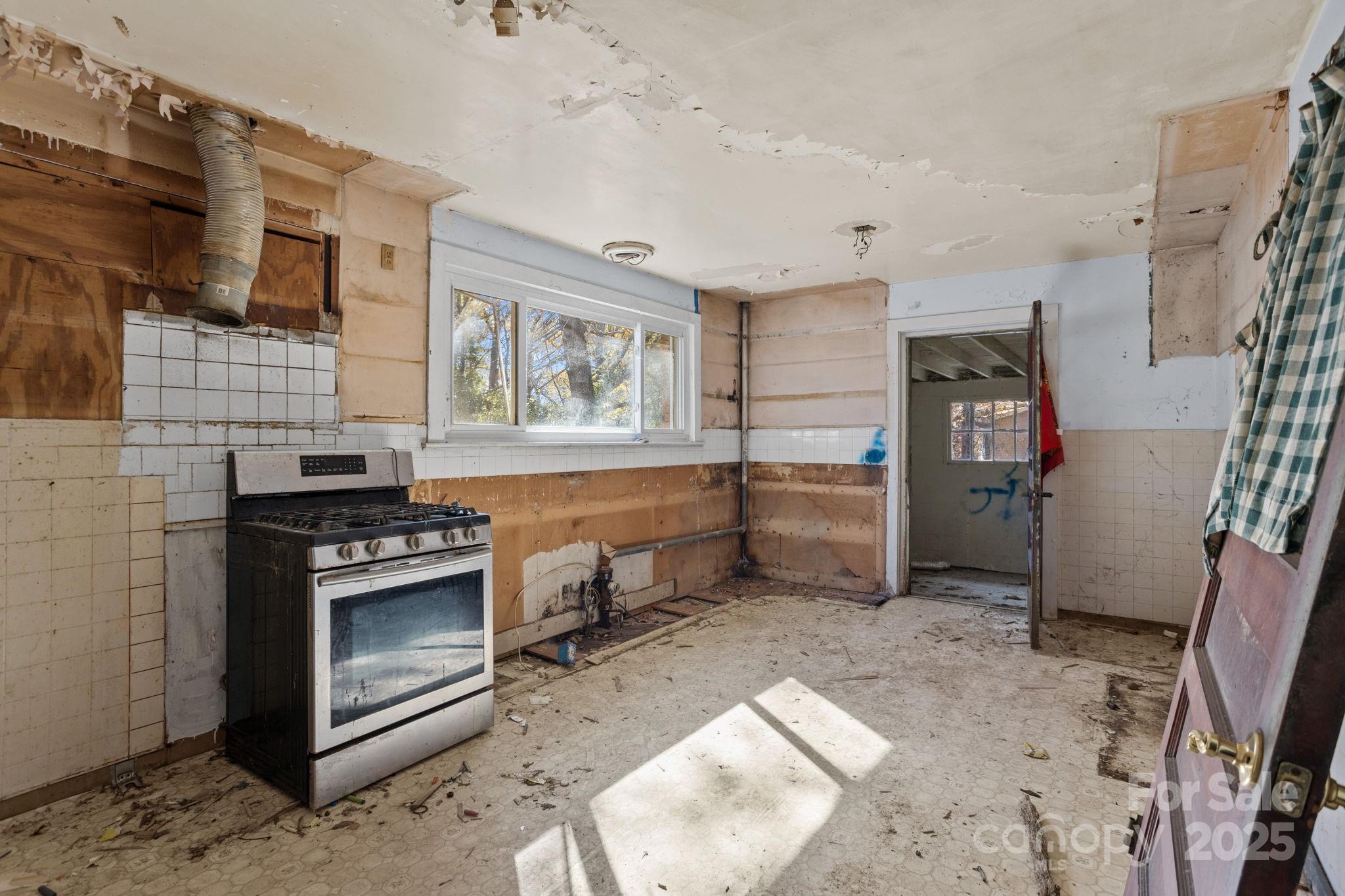 601 East Blue Ridge Road East Flat Rock, NC 28726 - Photo 6 of 48 a kitchen with a stove and a refrigerator