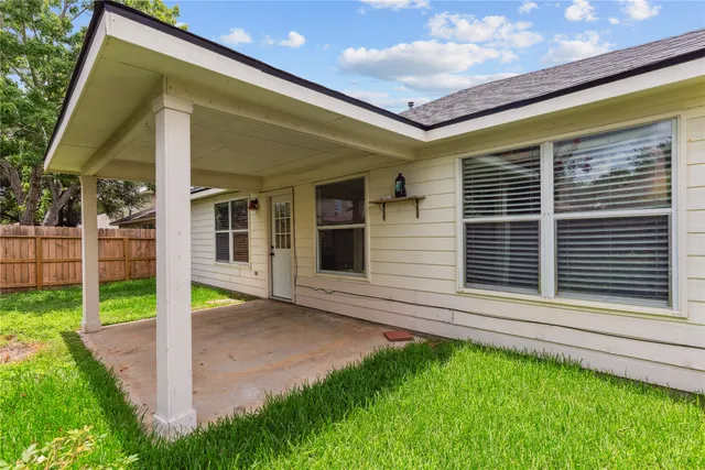 a view of house with backyard