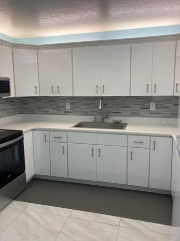 a kitchen with white cabinets