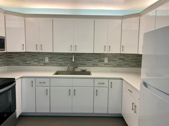 a kitchen with white cabinets