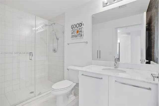 a bathroom with a sink toilet and shower