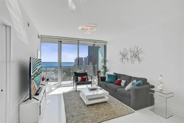 a living room with furniture and a large window