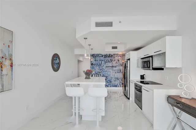 a kitchen with stainless steel appliances a microwave a stove and refrigerator