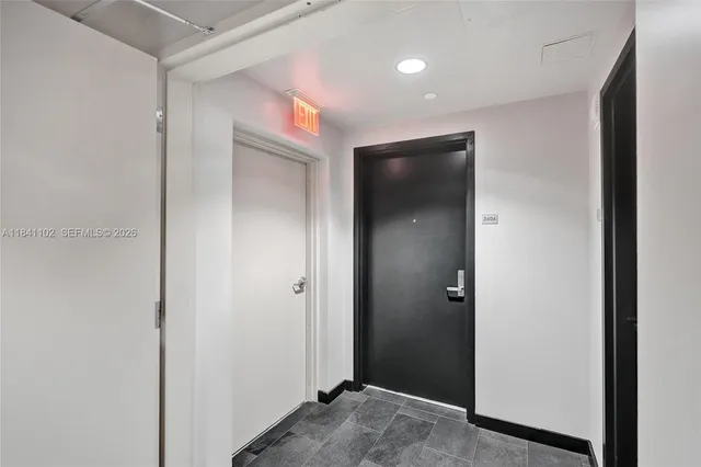 a living room with furniture kitchen view and a potted plant