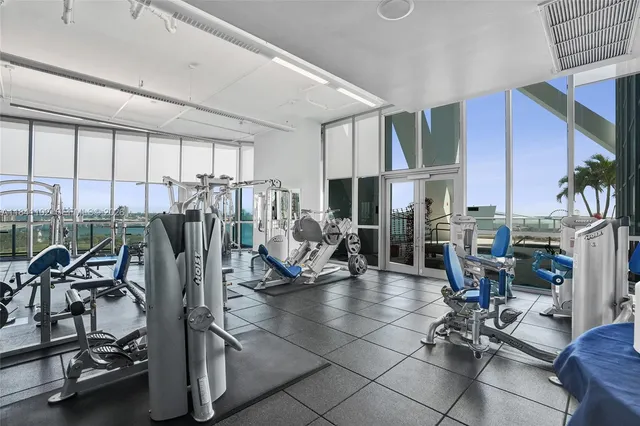a living room filled with furniture and floor to ceiling window