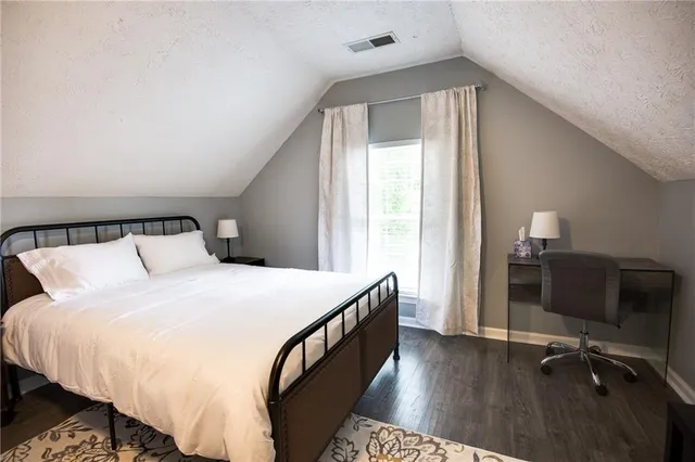 a bedroom with a bed and a desk