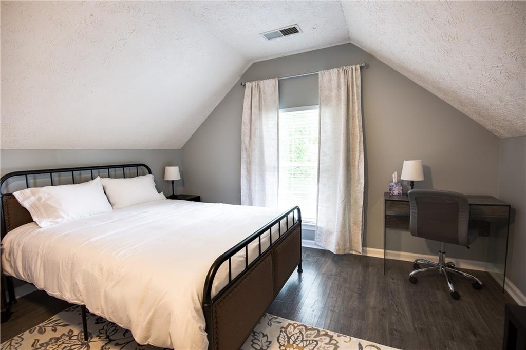 7151 Springchase Way Austell, GA 30168 - Photo 4 of 14 a bedroom with a bed and a desk