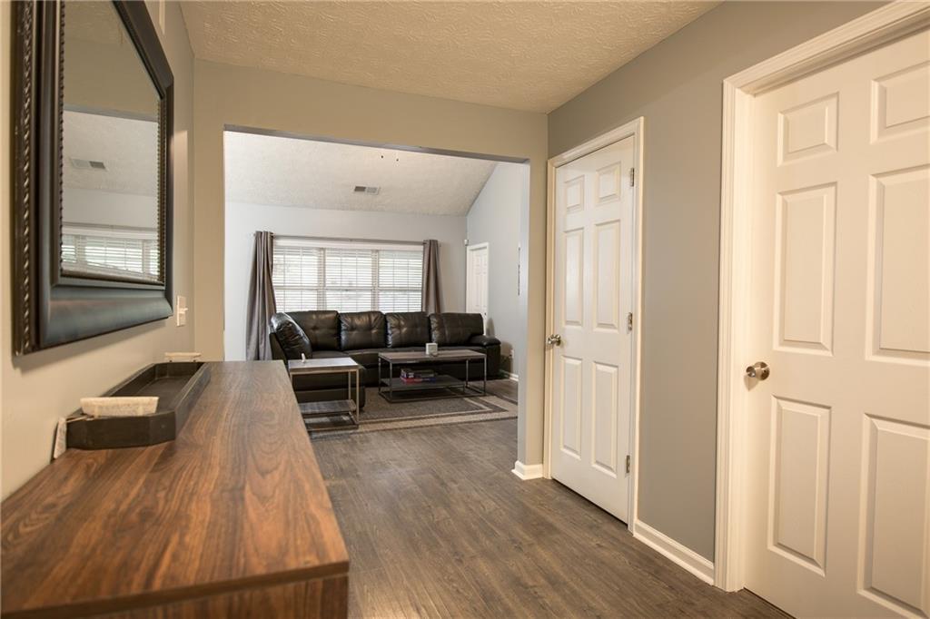 7151 Springchase Way Austell, GA 30168 - Photo 5 of 14 a living room with furniture and a large window