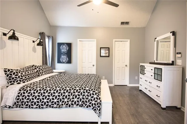 a bedroom with a bed and wooden floor