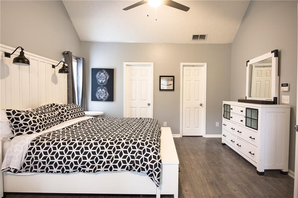 7151 Springchase Way Austell, GA 30168 - Photo 6 of 14 a bedroom with a bed and wooden floor