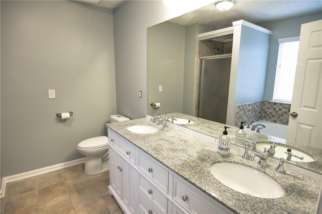 7151 Springchase Way Austell, GA 30168 - Photo 10 of 14 a bathroom with a granite countertop sink toilet and mirror