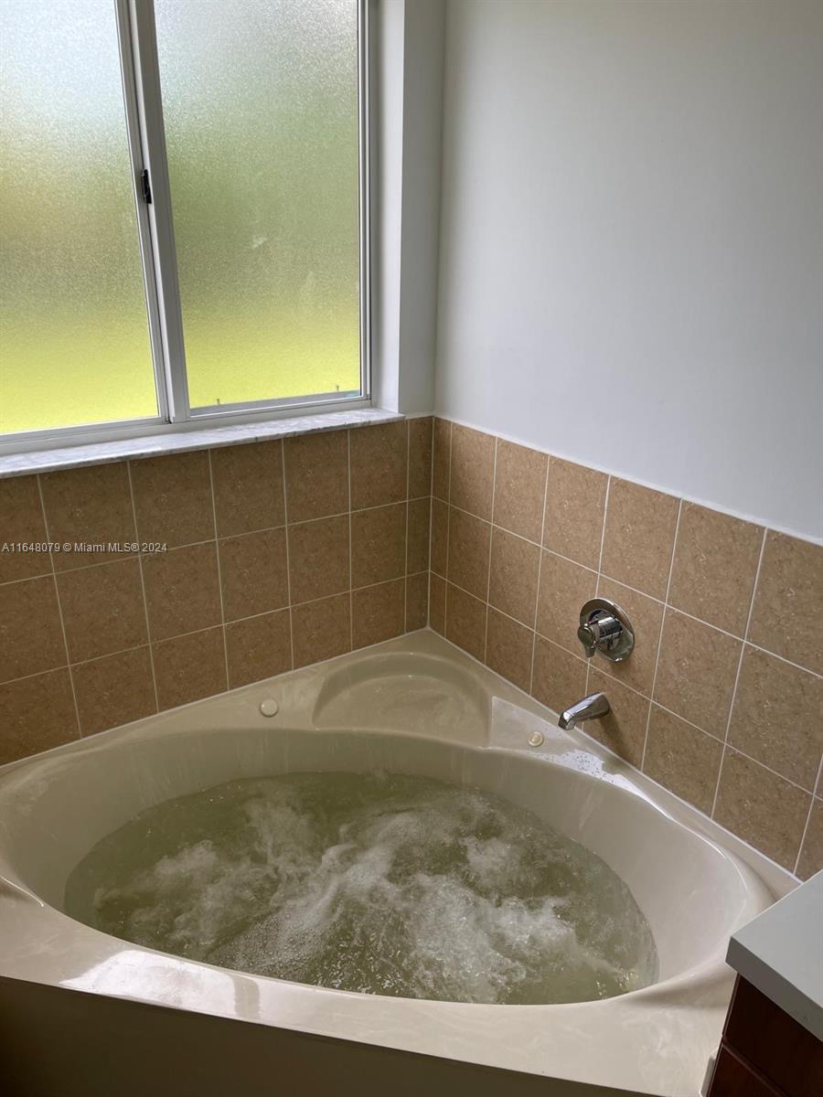32050 Southwest 204th Avenue Homestead, FL 33030 - Photo 11 of 36 a bathroom with a bath tub