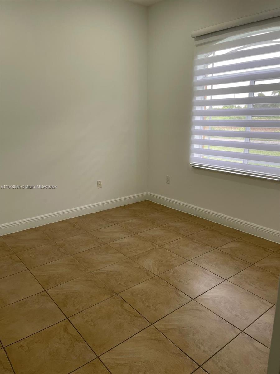 32050 Southwest 204th Avenue Homestead, FL 33030 - Photo 17 of 36 a view of an empty room with a window