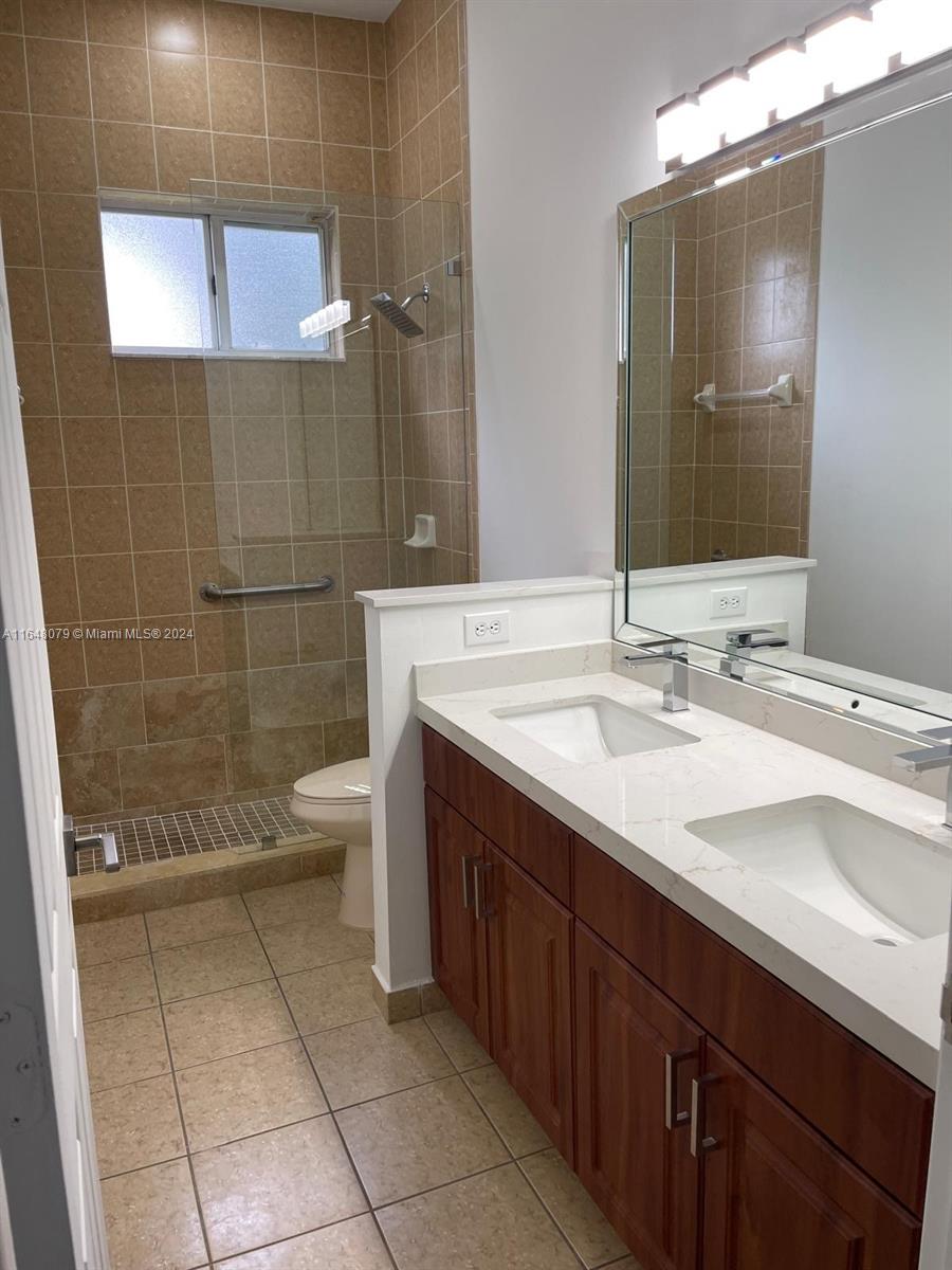 32050 Southwest 204th Avenue Homestead, FL 33030 - Photo 19 of 36 a bathroom with a sink a toilet and shower