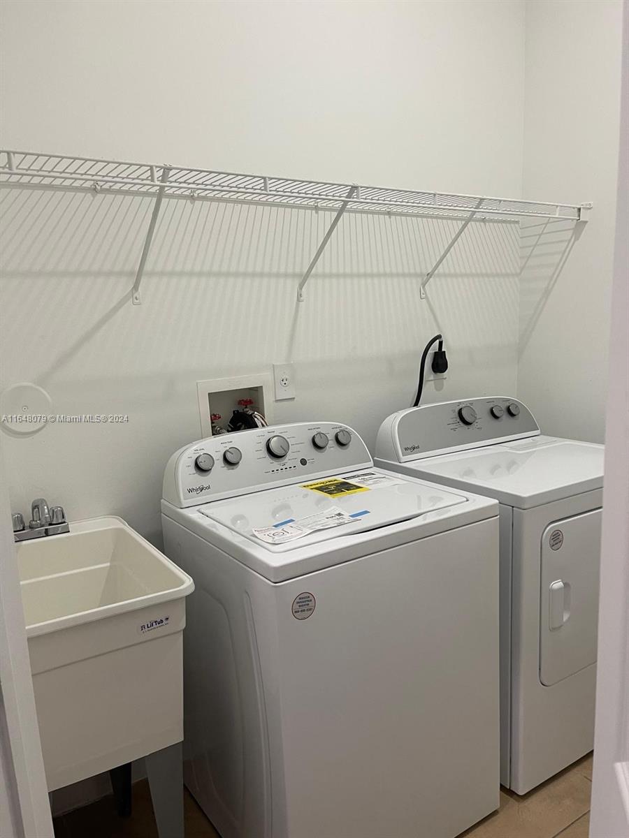 32050 Southwest 204th Avenue Homestead, FL 33030 - Photo 26 of 36 a utility room with dryer and washer
