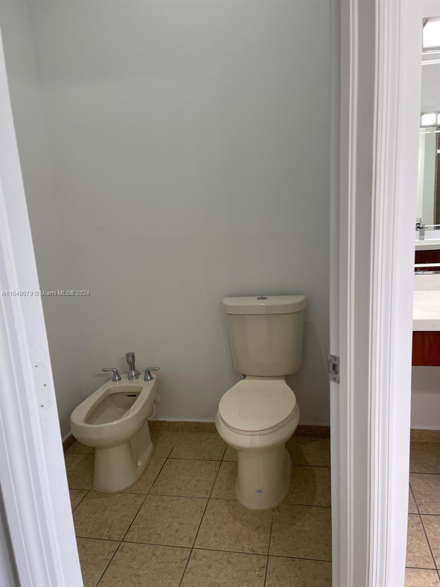 32050 Southwest 204th Avenue Homestead, FL 33030 - Photo 8 of 36 a white toilet sitting next to a bathroom sink