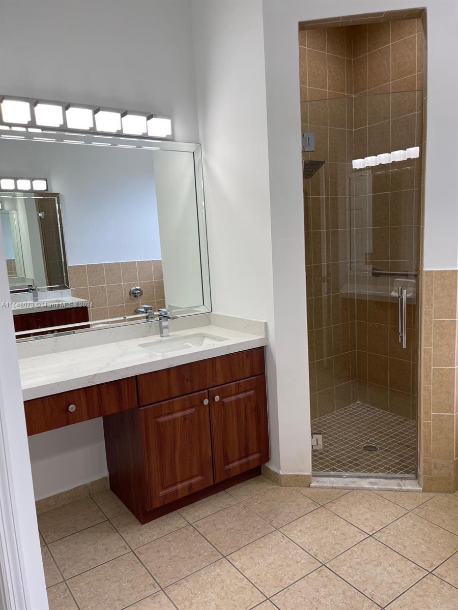 32050 Southwest 204th Avenue Homestead, FL 33030 - Photo 9 of 36 a bathroom with a sink and a mirror