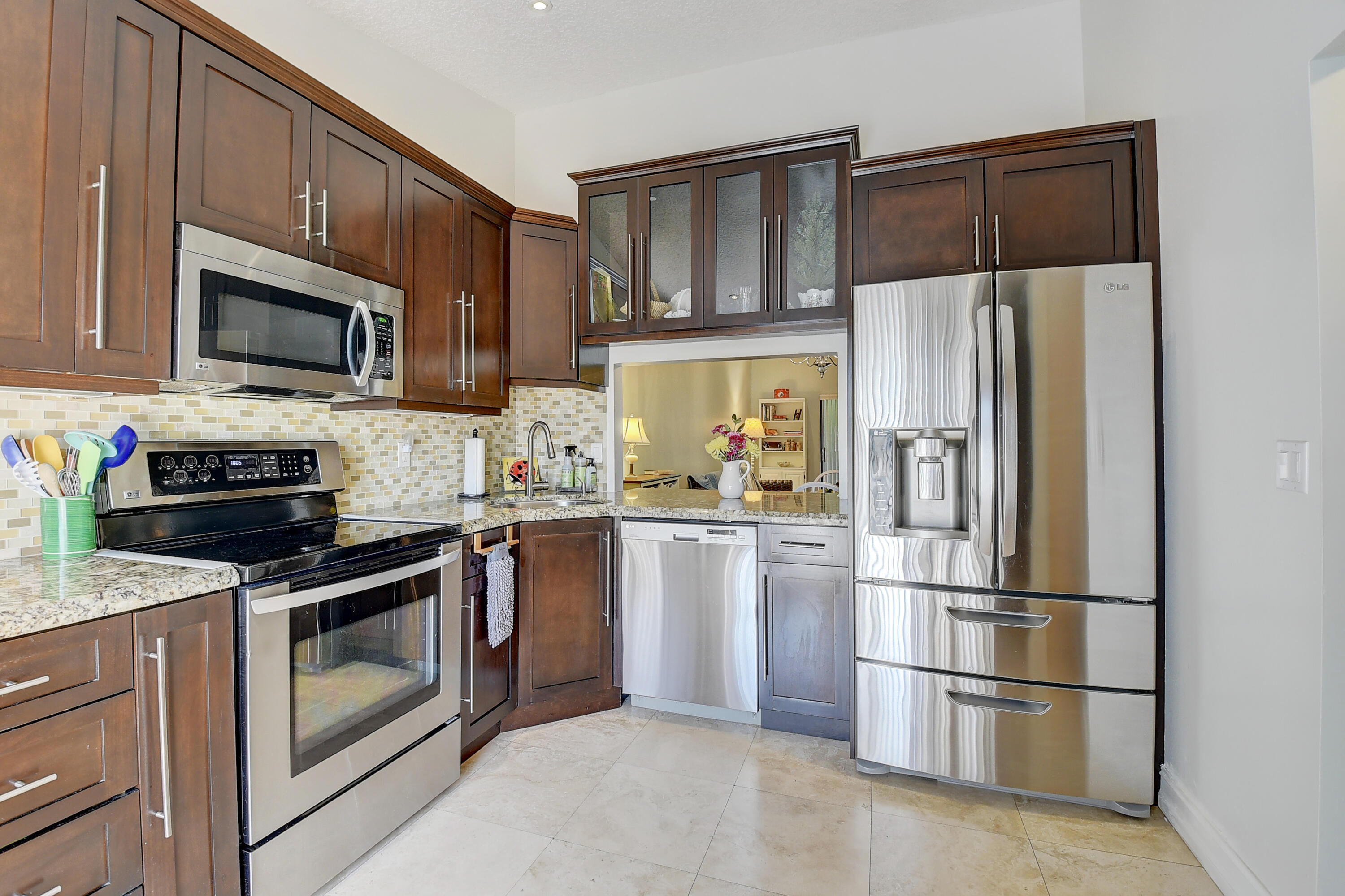 8458 Boca Glades Boulevard East Boca Raton, FL 33434 - Photo 1 of 28 a kitchen with granite countertop a refrigerator stove and microwave