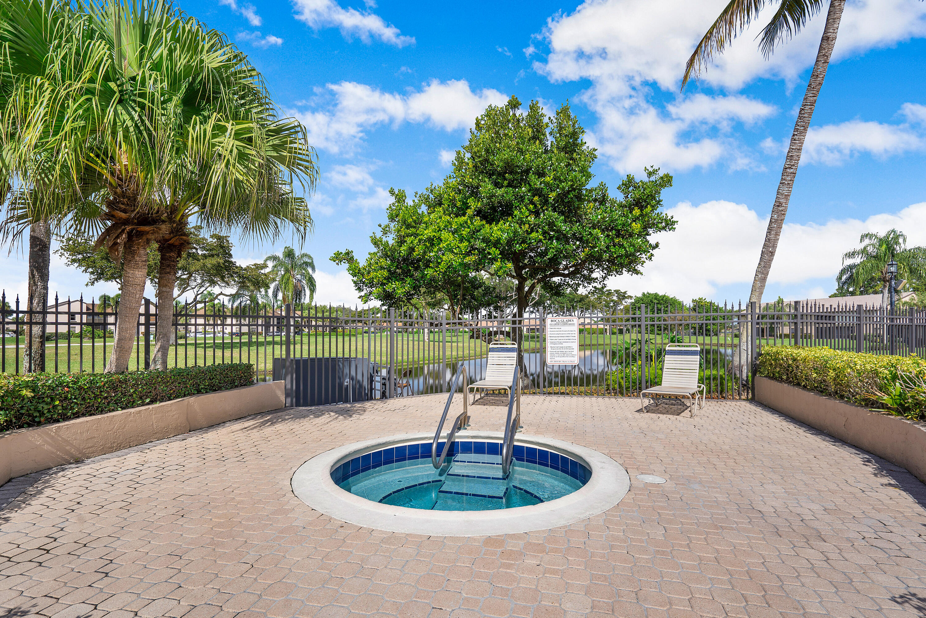8458 Boca Glades Boulevard East Boca Raton, FL 33434 - Photo 26 of 28 a swimming pool with outdoor seating and green space