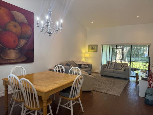 8458 Boca Glades Boulevard East Boca Raton, FL 33434 - Photo 5 of 28 a view of a dining room with furniture a chandelier and a large window