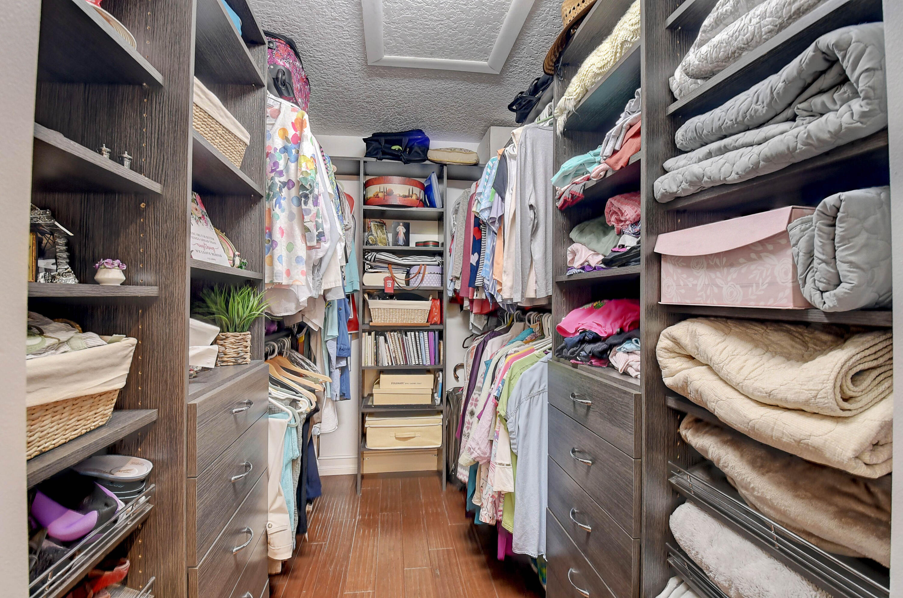 8458 Boca Glades Boulevard East Boca Raton, FL 33434 - Photo 7 of 28 a view of walk in closet with clothes and shoes