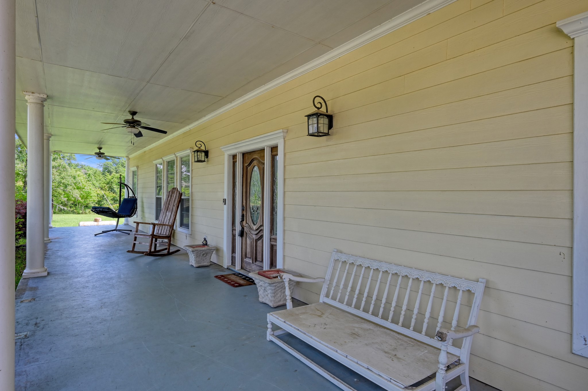 144 Wood Farm Road Huntsville, TX 77320 - Photo 3 of 35 a view of a porch with wooden floor and fence