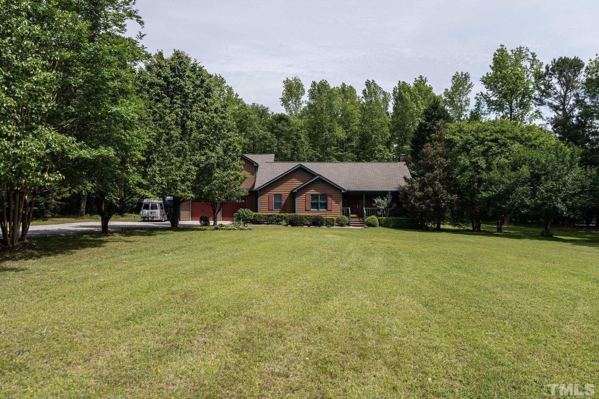 920 Wagstaff Road Fuquay-Varina, NC 27526 - Photo 1 of 58 a front view of a house with a yard and trees