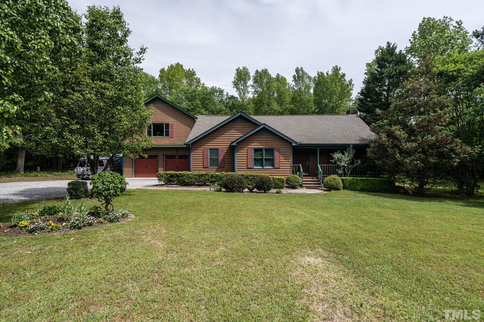 920 Wagstaff Road Fuquay-Varina, NC 27526 - Photo 2 of 58 a front view of a house with a yard and trees