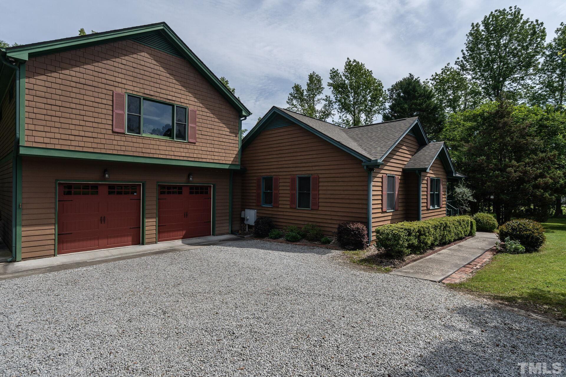 920 Wagstaff Road Fuquay-Varina, NC 27526 - Photo 4 of 58 a front view of a house with a yard and garage