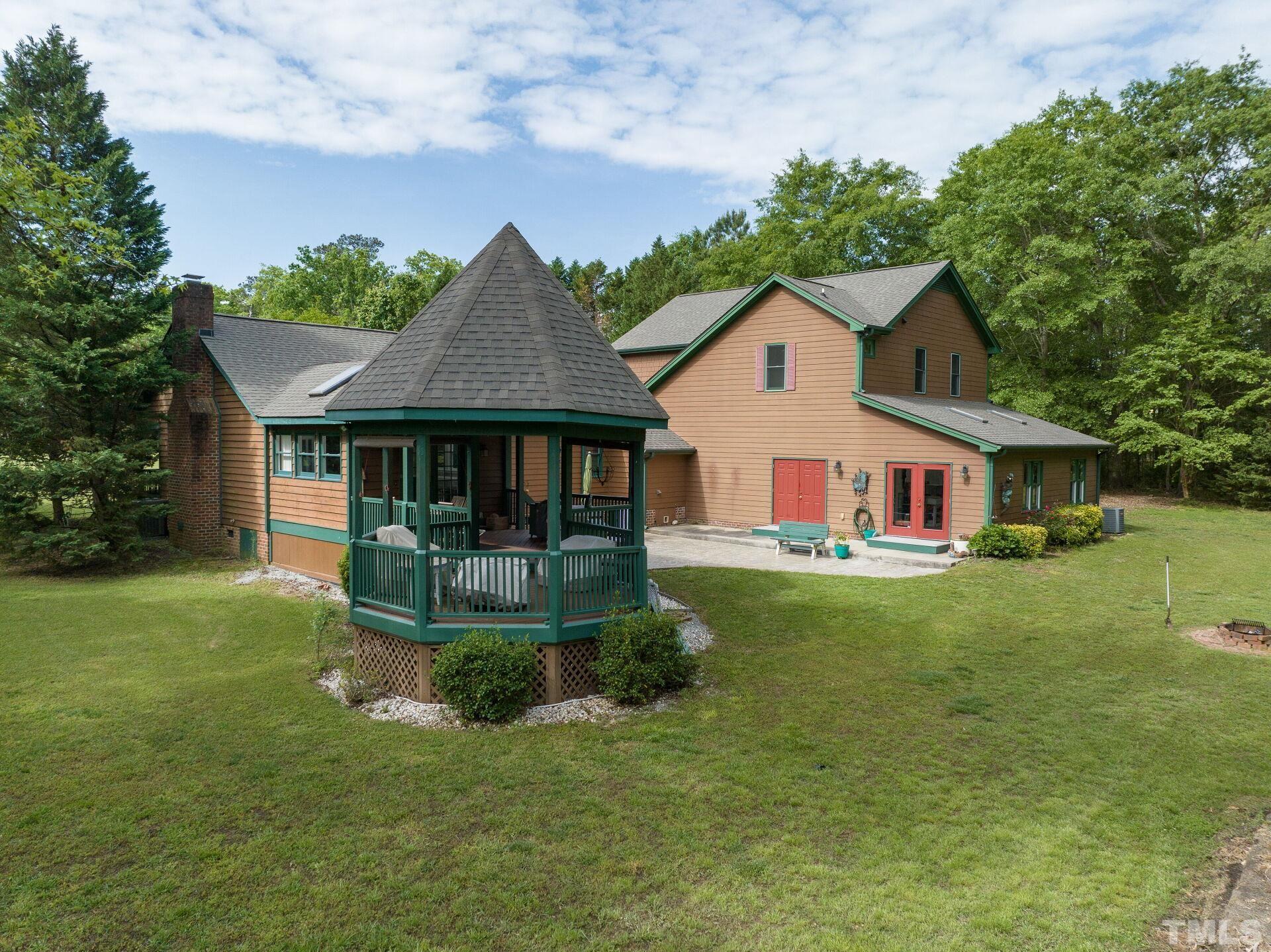 920 Wagstaff Road Fuquay-Varina, NC 27526 - Photo 44 of 58 a front view of a house with a yard table and chairs