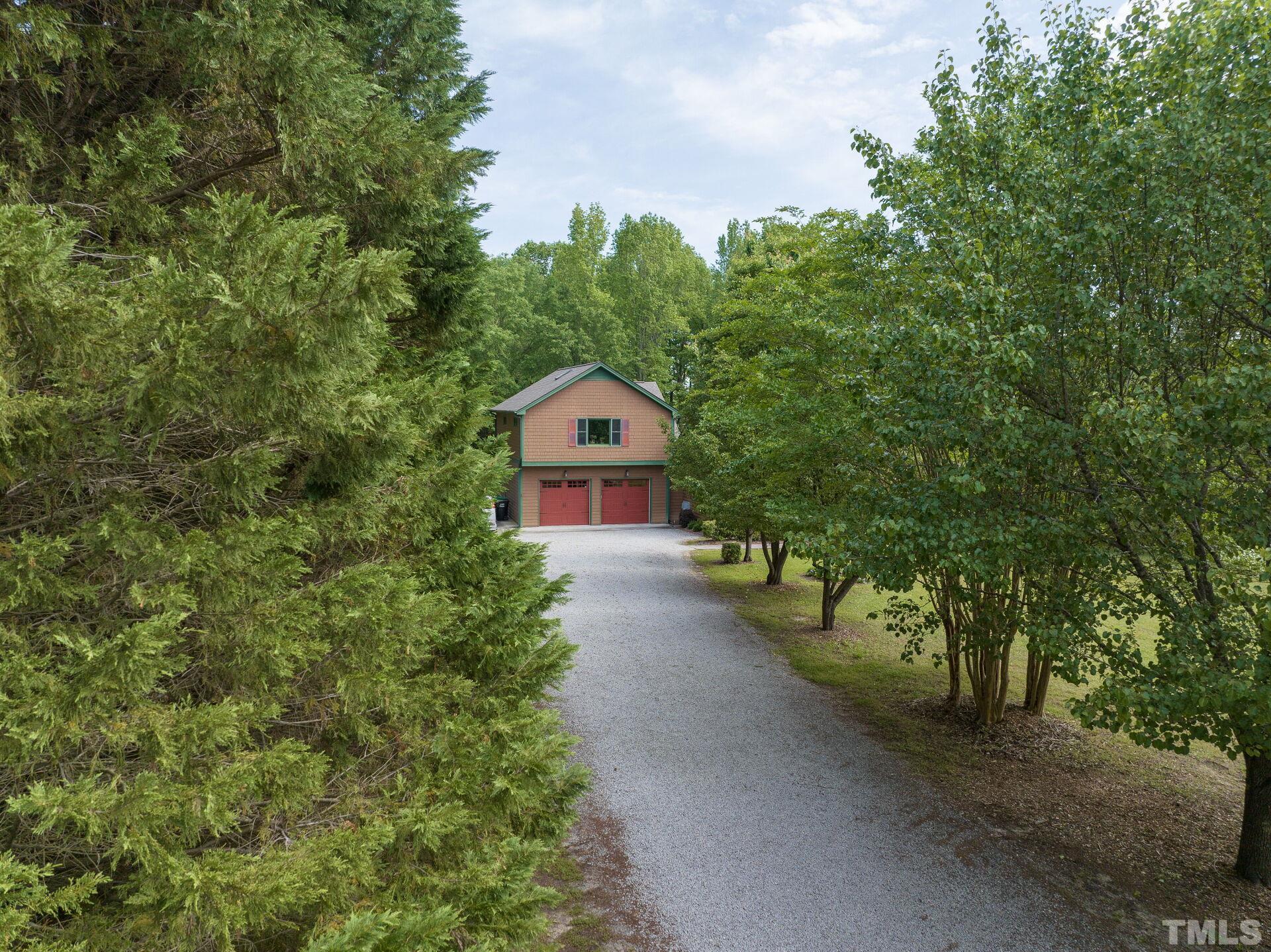 920 Wagstaff Road Fuquay-Varina, NC 27526 - Photo 45 of 58 a view of a house with a small yard and large trees
